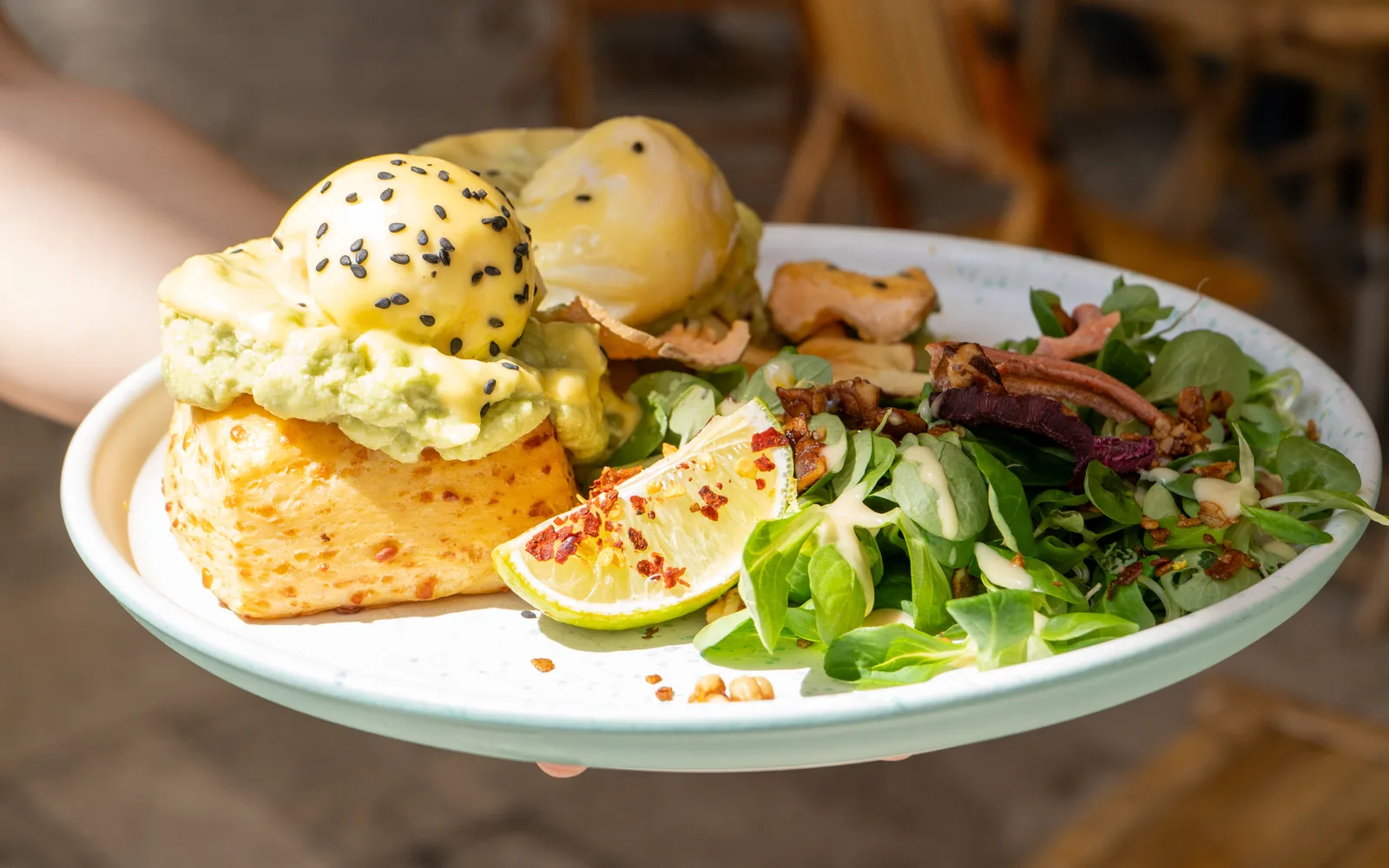 Eggs Benedict on cheddar scones with hollandaise and avocado-feta smash at Cookie Beacon