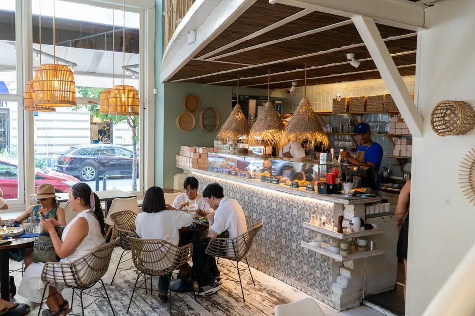 Guests eating brunch at tables beside the counter at Cookie Beacon near St. Stephen's Basilica
