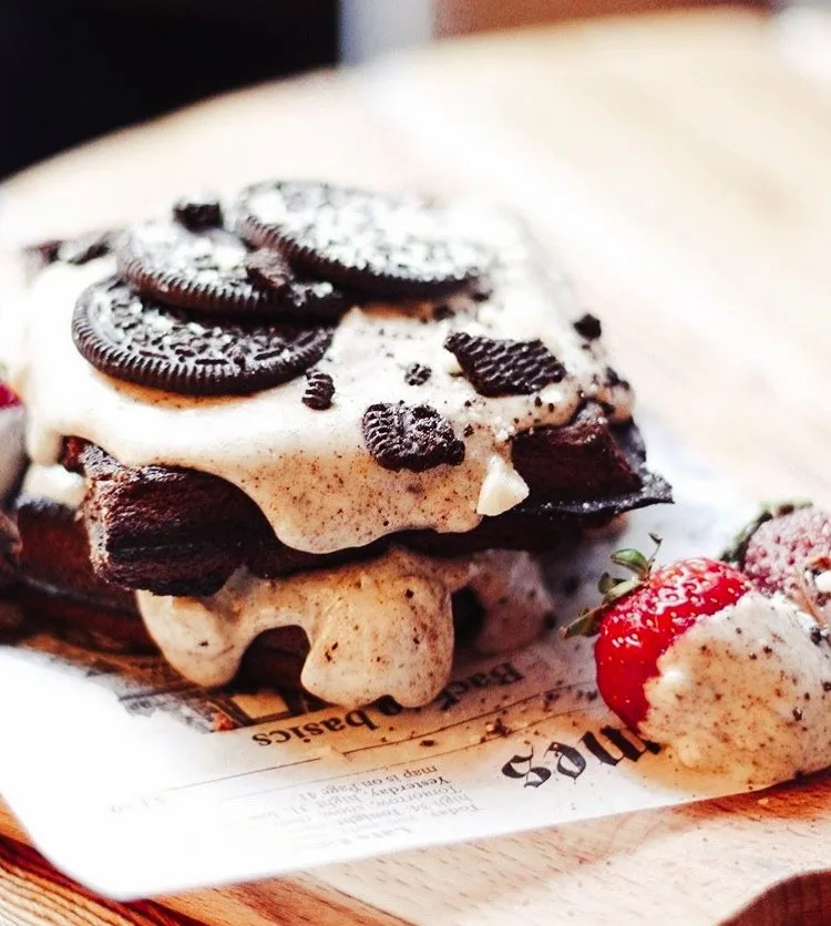 Oreo waffles stacked with Oreo cream and fresh strawberries