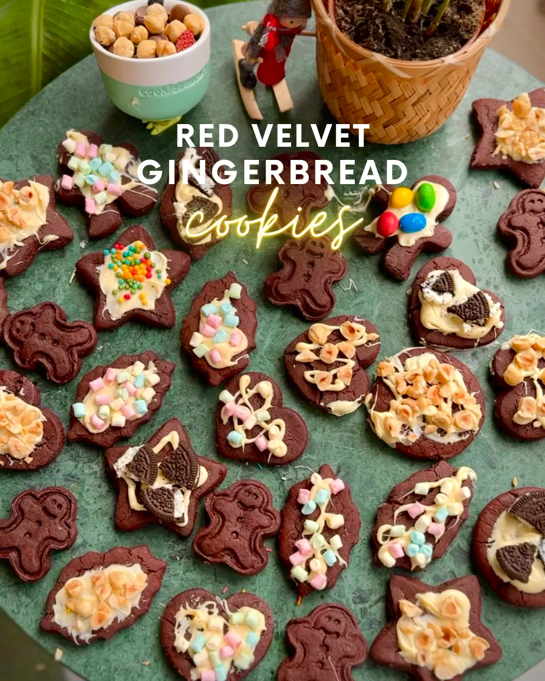Red velvet gingerbread cookies cut into stars, hearts and gingerbread men, decorated with white chocolate, Oreo pieces, hazelnuts and mini marshmallows